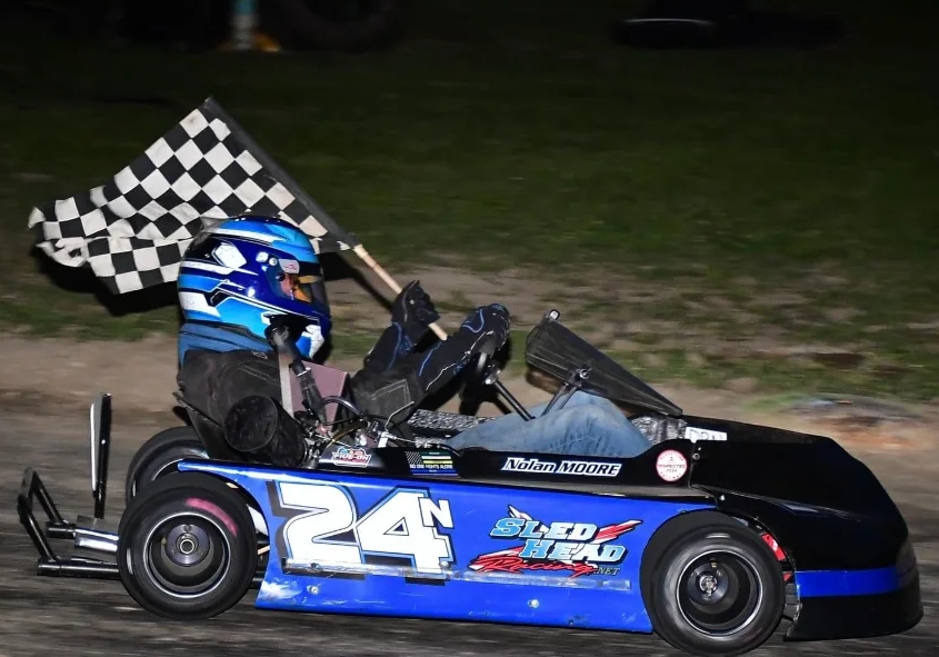 race winner with checkered flag in go kart